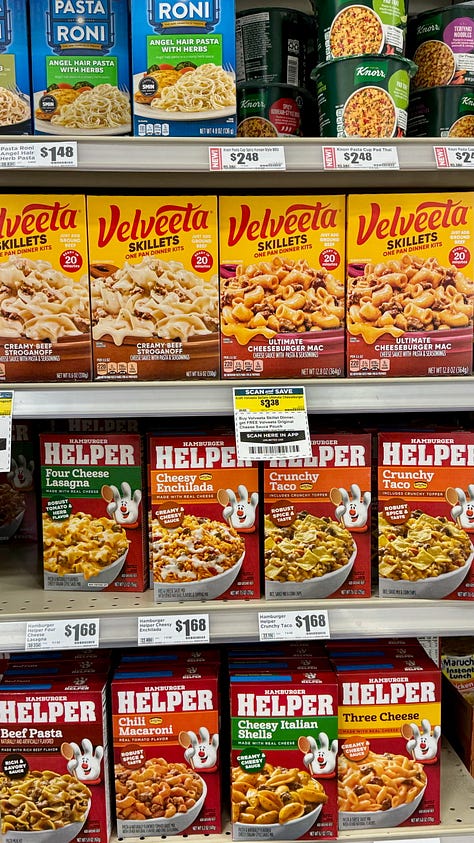 Shelves of hair-care products, hip-hop themed chips, and meals in a box.