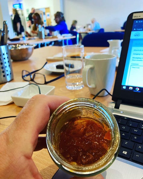 Check jacket with Great Taste Awards, jar of marmalade being examined with a computer in the background, arancini sliced in half, with cutlery and Great Taste staffer in the background. 