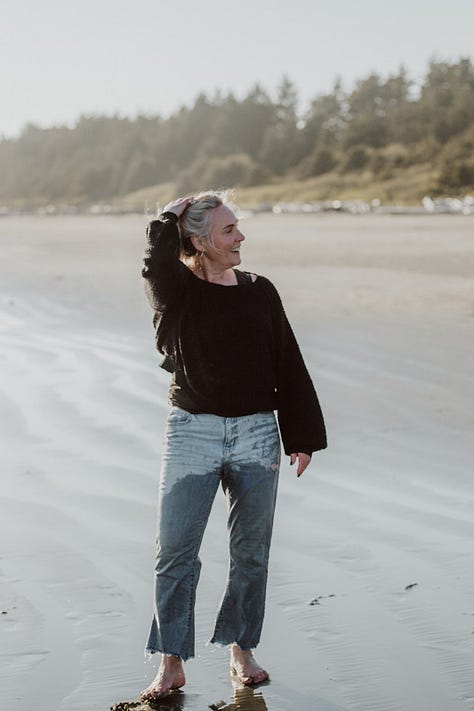 Photographer Tamara Dayle runs fully clothed in the Pacific Ocean outside Tofino BC 