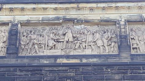 From left: Garfield's statue in the atrium. A fresco depicting a personification of Liberty. The external frieze depicting Garfield at center.