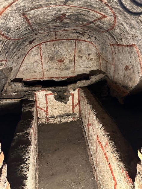 The tomb of Saint Felix adorned with decorations, including an angel, a dove and a fish