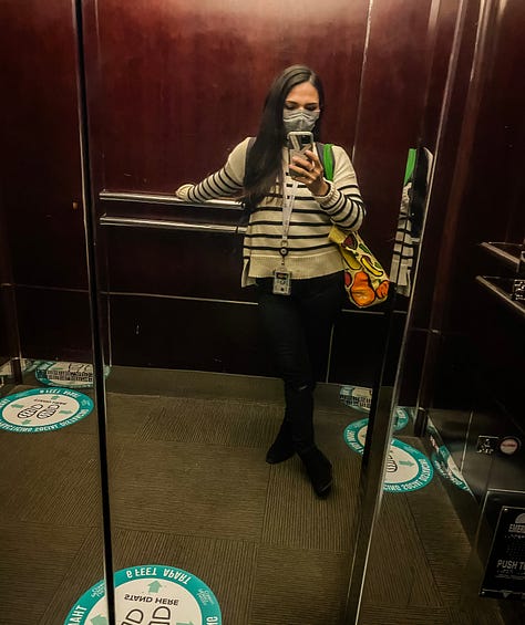 Mirror selfie photo of woman in an elevator wearing a mask and social distancing markers on the floor of the elevator, mirror selfie of a woman, mirror selfie of a woman