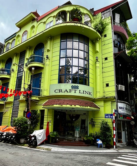 the Religion Publishing House, a pho stand, people cooking meat on the street for banh mi and bun cha, and Craft Link, a social enterprise shop encouraging economic development and helping rural women support themselves by "seeking new markets for traditional artisans."    