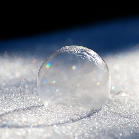 A series of three images shows a frozen bubble deflating and shattering.