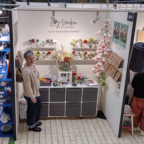 Images of my stand at Great Northern Contemporary Craft Fair, Victoria Baths, Manchester. The walls are white with colourful,paper wildflowers on shelves and a giant paper foxglove in one corner.