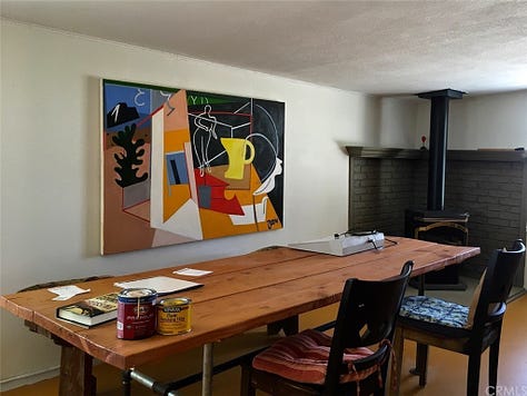 One row of three photos, left to right: Photo of two chairs and a rectangular wooden table topped with paint cans, papers, and a book, backed by a hanging frame of colorful artwork and a black and dark green stone fireplace; Photo of the high-ceilinged garage studio workshop filled with buckets, cans, tools, including for welding, and a large metal sculpture hanging from the rafters; Photo of a woman and man, both laughing and wearing hats, lay on lounge chairs in the sun with books at their sides, next to a large white wooden bird house with tucked-in bird feeder.