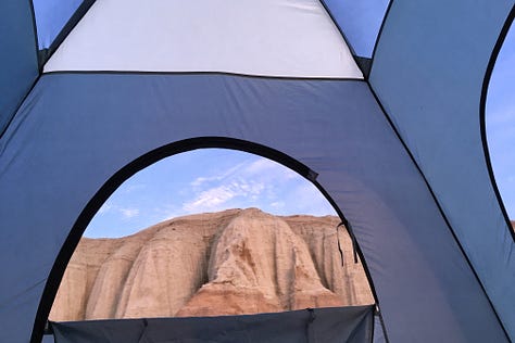 Three images of red rock hoodoos framed by the unzipped windows of a blue tent.