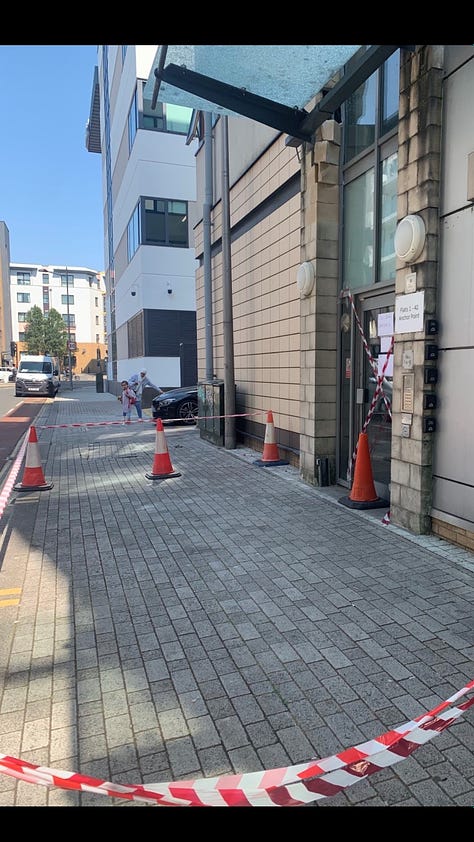 Images of the front door of a building where the glass canopy has been cracked and the area below has been sealed off with cones and orange and white tape