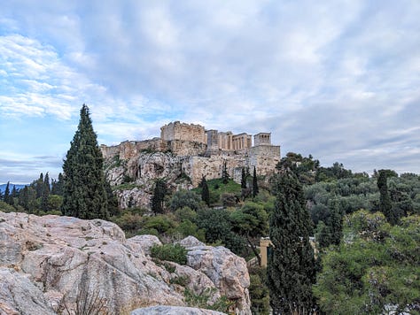 View of the Acropolis, author on Mars Hill, and a dog by Greek ruins