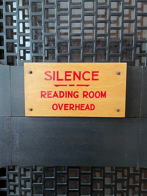 1) An off-white balcony supported by ornate pillars, 2) Benches perched among overgrowth of weeds and plant life, 3) A sunrise or sunset seen through the trees in a lush area, 4) A burning candle held up to an orange sunset, 5) A wooden sign which reads "Silence, reading room overhead" in red, capital letters, 6) Small metal sculptures of climbers, mounted onto wood panelled walls with coat & hat hooks, 7) An arched, pillared & decorated stone ceiling of a library, 8) A city sunrise reflected in a mirror.