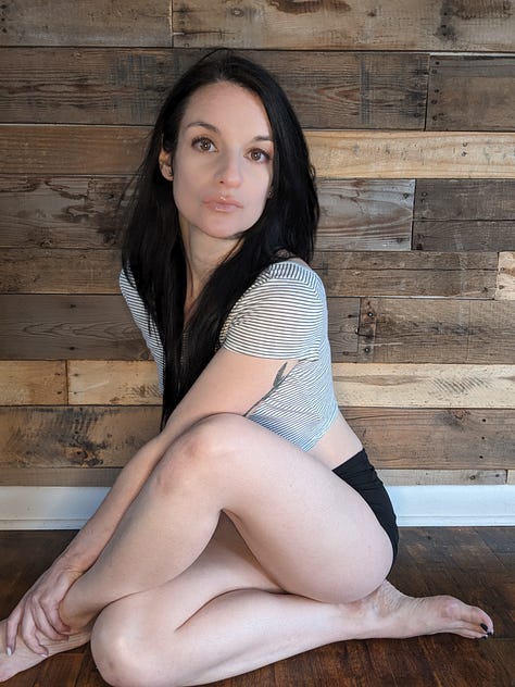 Beautiful woman sitting on living room floor.