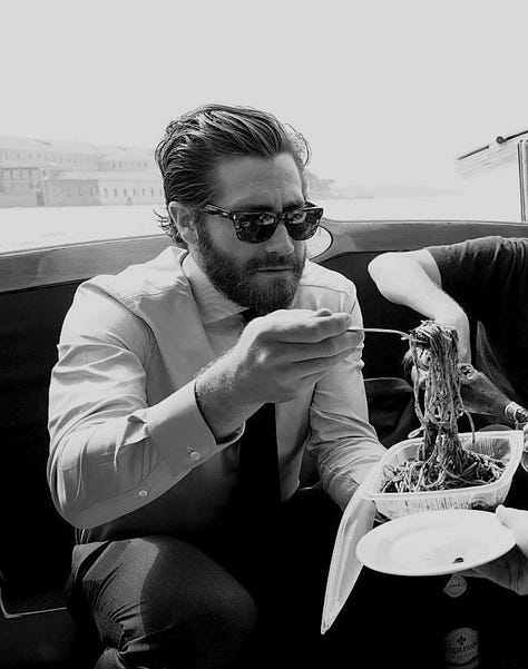 Pictures of Jake Gyllenhaal eating food or posing with food. 