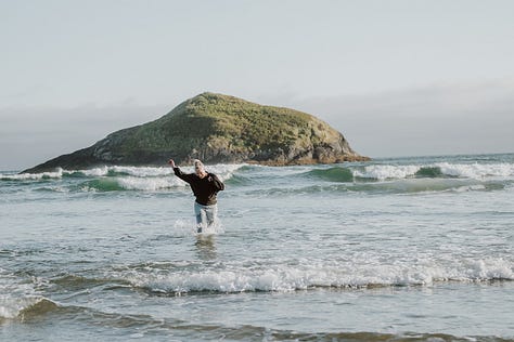 Photographer Tamara Dayle runs fully clothed in the Pacific Ocean outside Tofino BC 