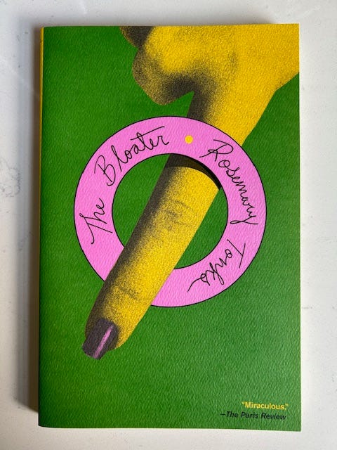 The Bloater by Rosemary Tonks has a green background and a bright pink ring around a finger.