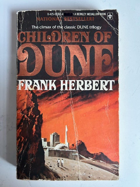 Children of Dune has a brown and orange cover.