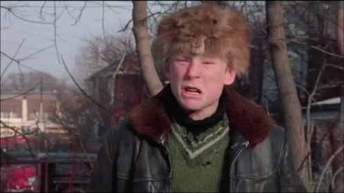 a boy wearing a fur hat and a leather jacket