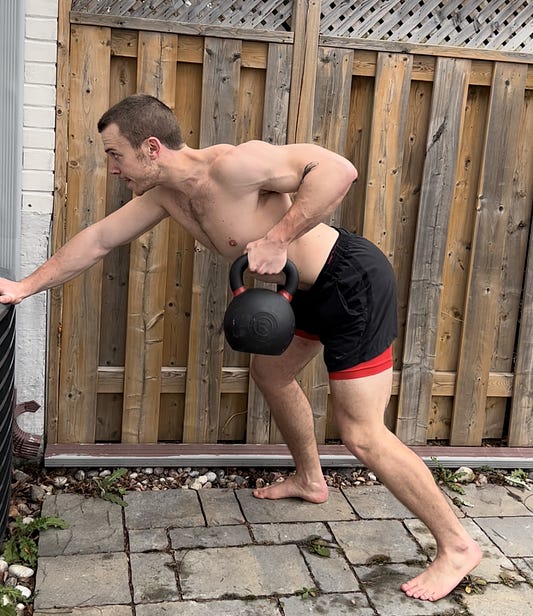 Kettlebell rows outdoors.