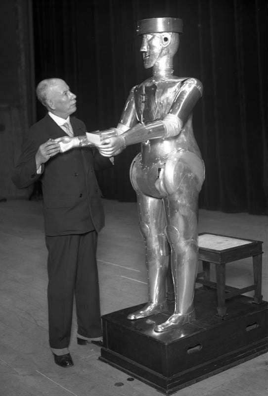 Black and white photo of a man with a robot