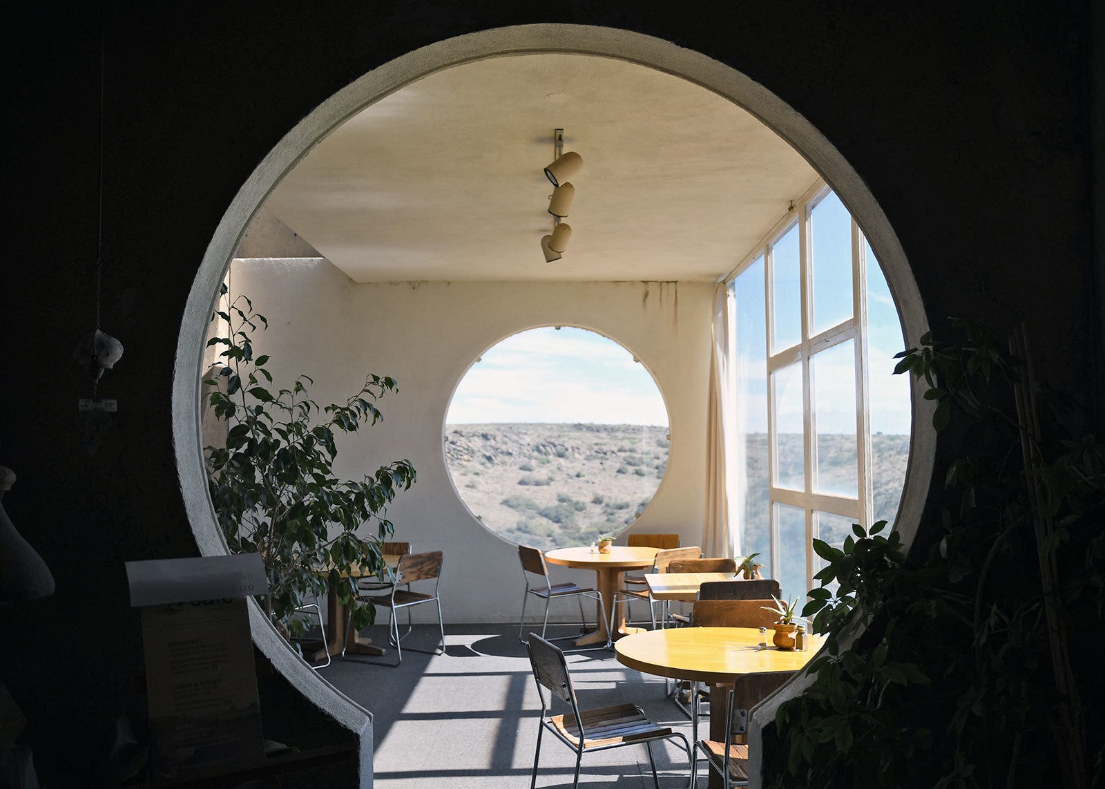 A beautiful view onto a landscape through a window from inside Arcosanti