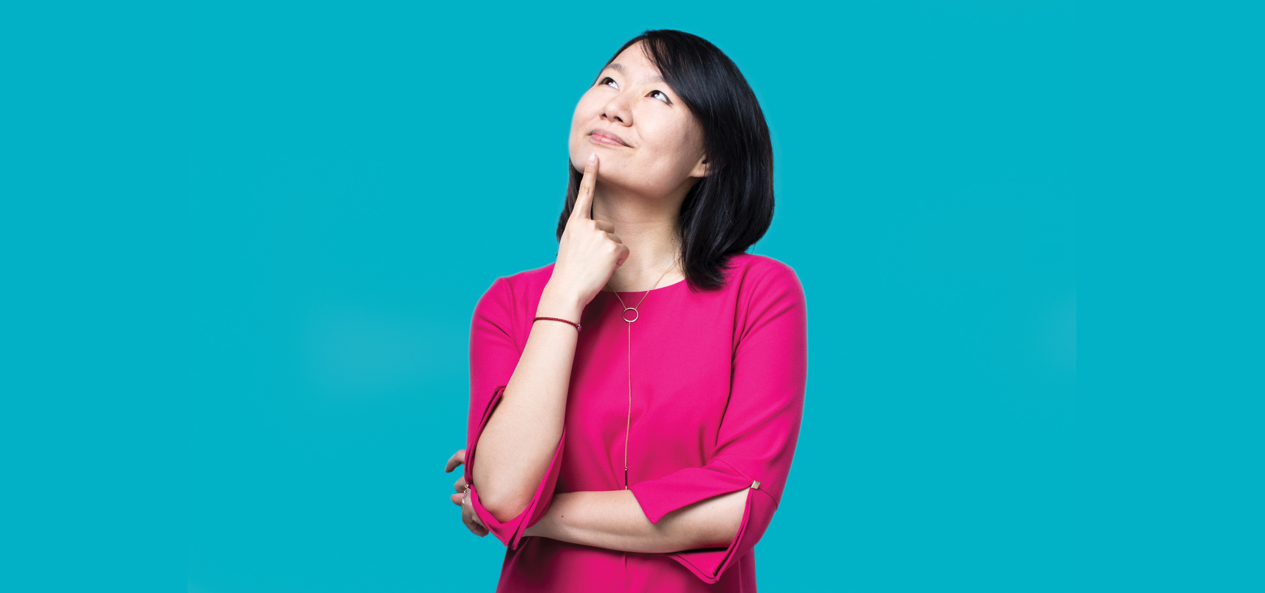 Jing Jing Tan posing while looking upwards and smiling.