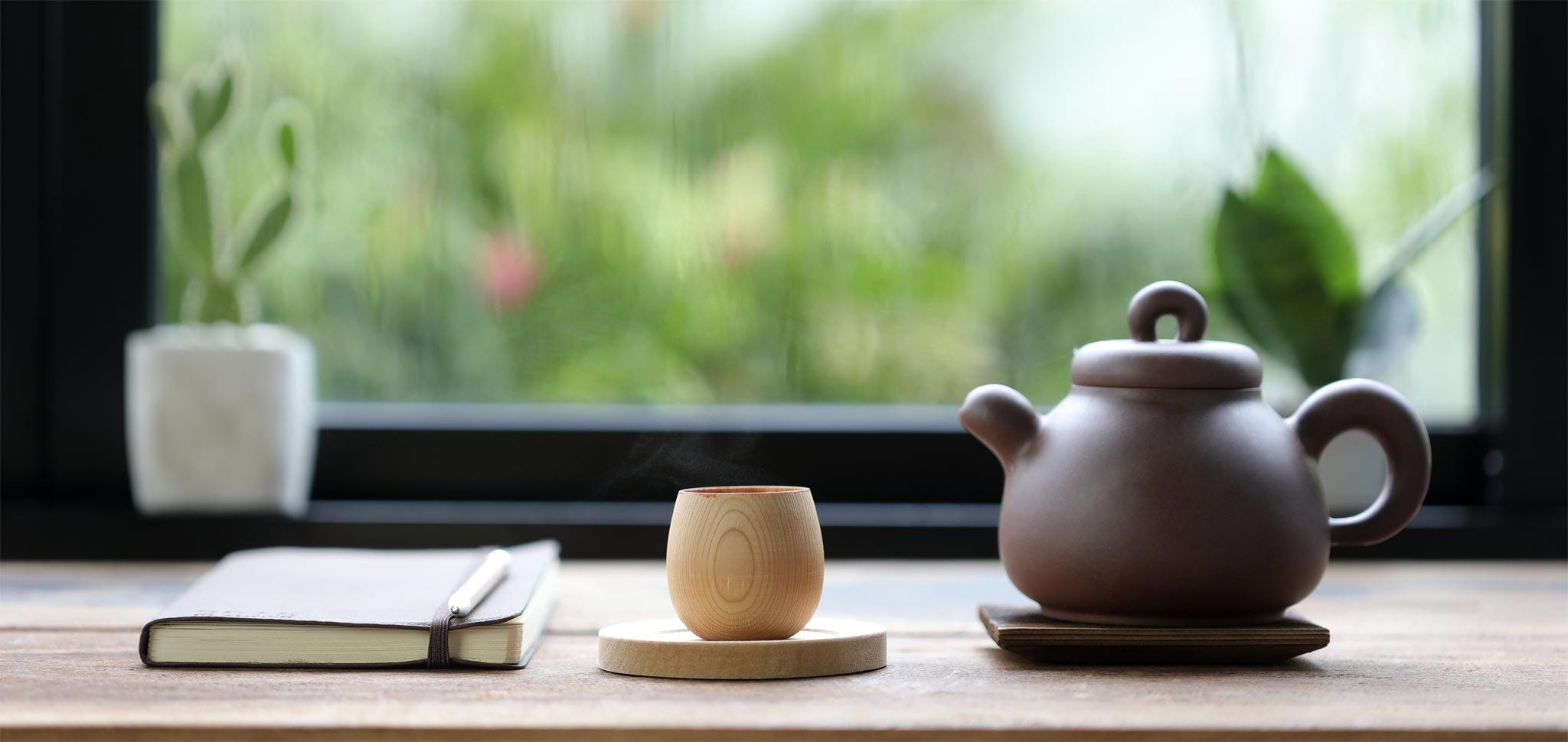 Teapot, cup, and writing notebook. Writing rituals including your own tea ritual can help you get in the writing mindset.