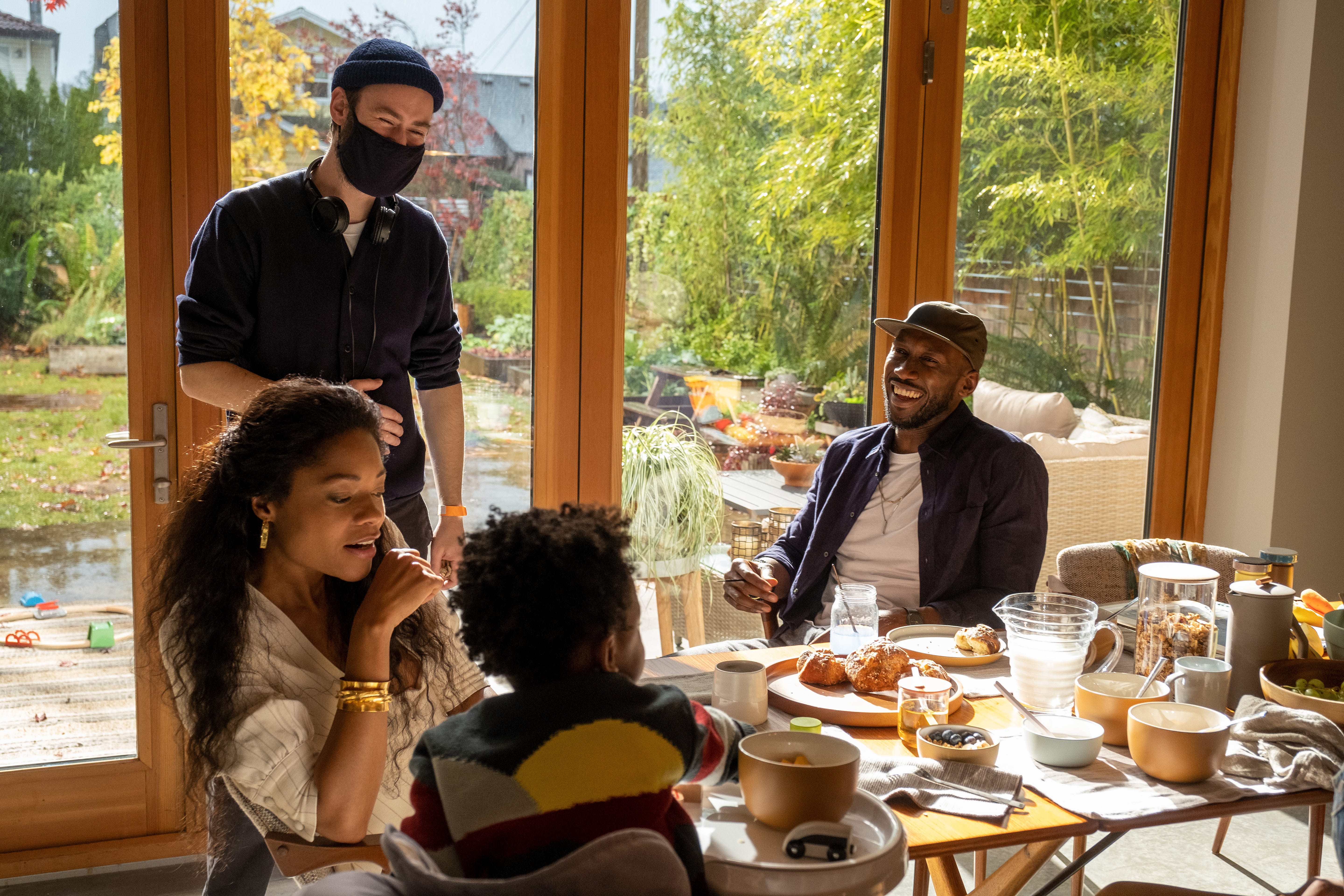 actors Ace Lever, Naomie Harris, Mahershala Ali share a laugh with a masked writer-director Benjamin Cleary behind the scenes of "Swan Song."