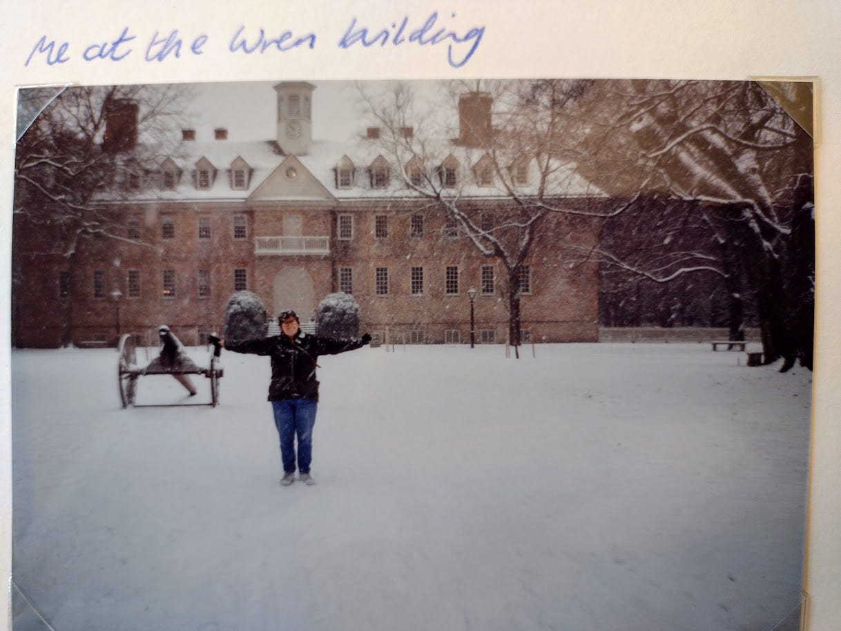 Young Annette standing in snow in front of colonial Building