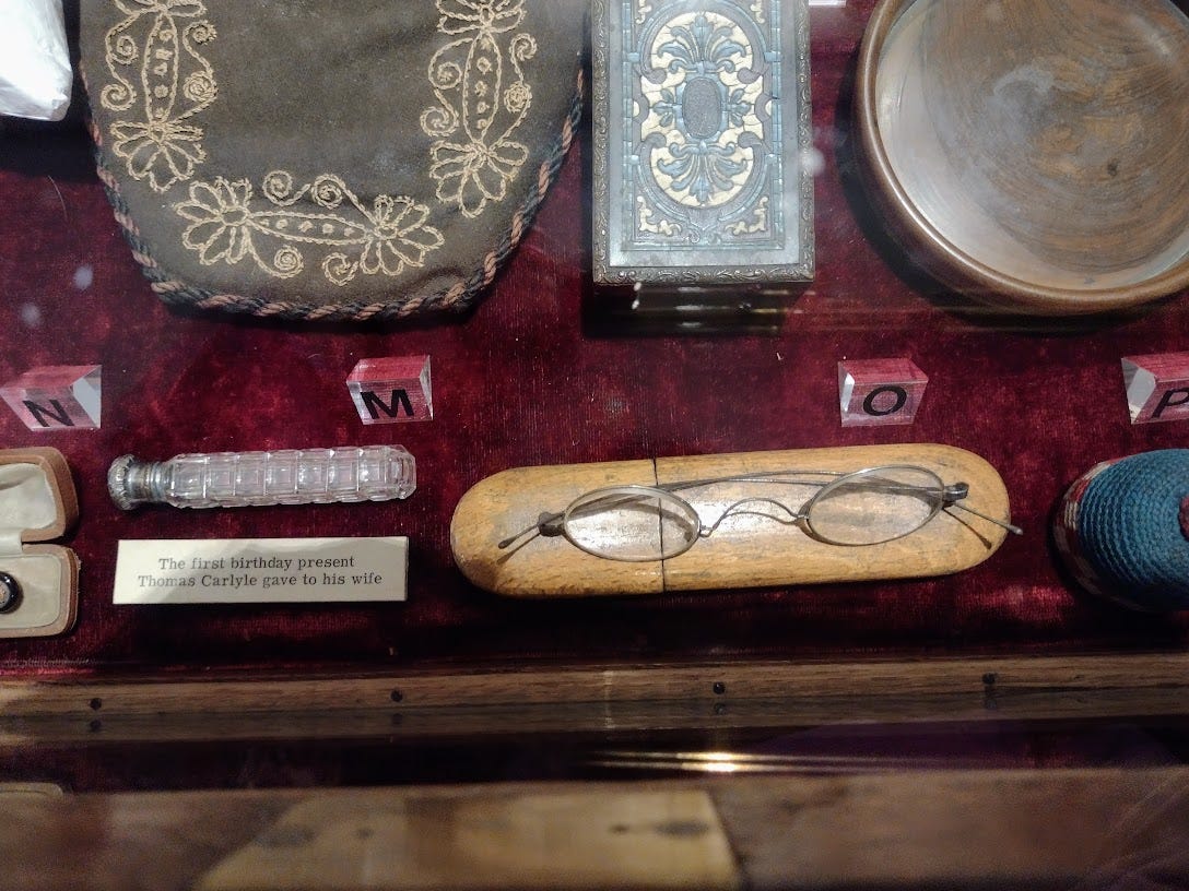 Collection of small belongings, including eye classes and a small glass vial
