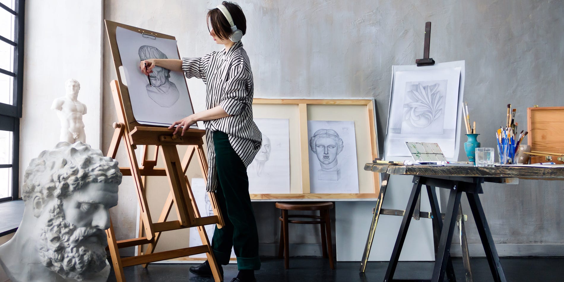 Artist sketching before painting representing writers' first draft.