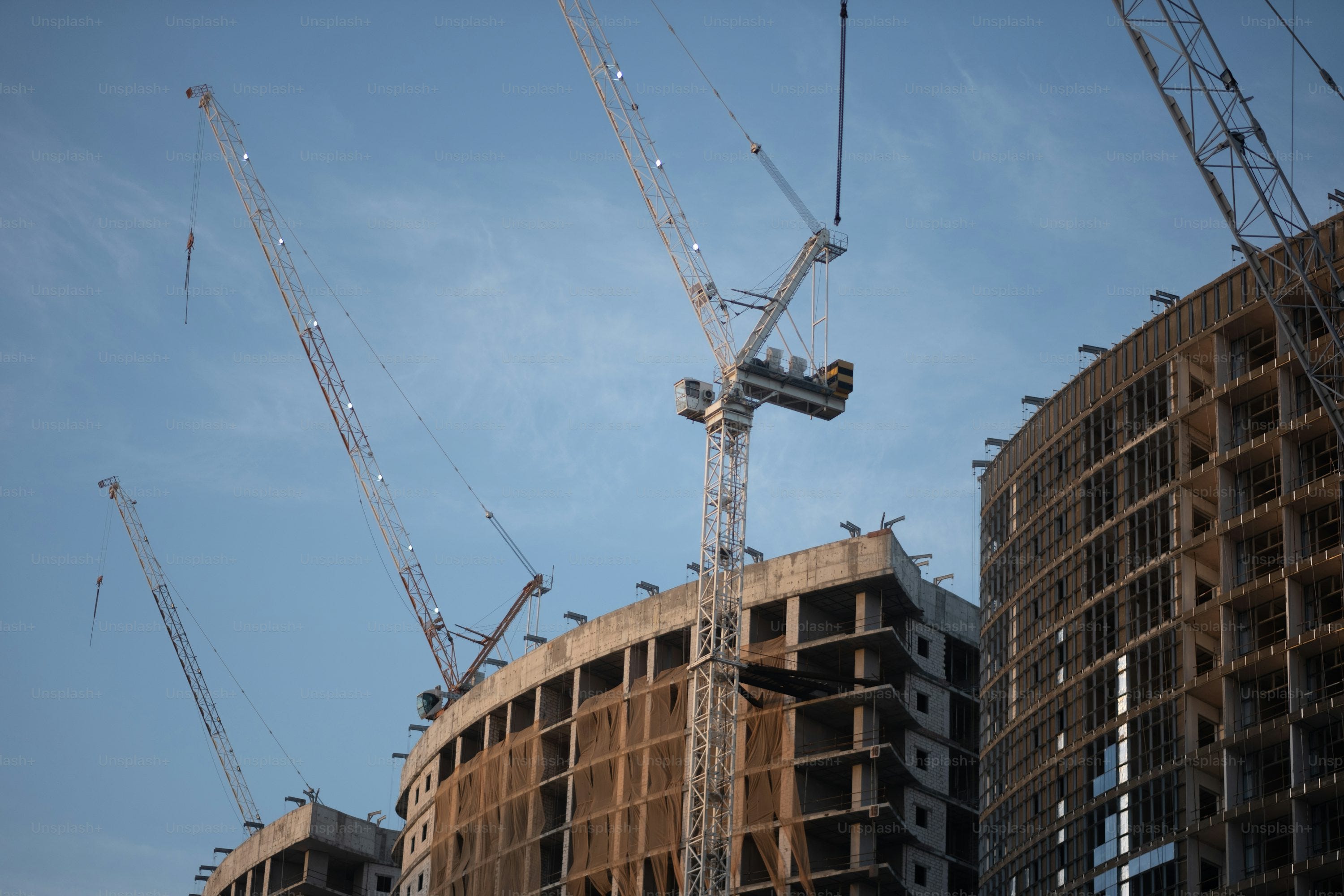 a group of cranes that are standing in the air