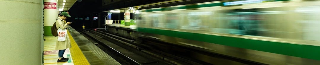 white and green train in train station