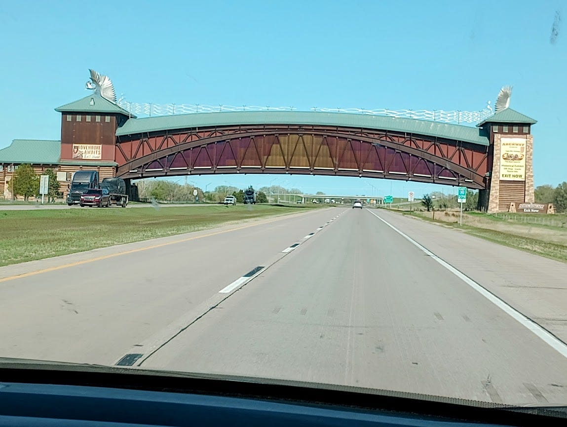 Massive arch-shaped building that crosses four lanes of busy freeway