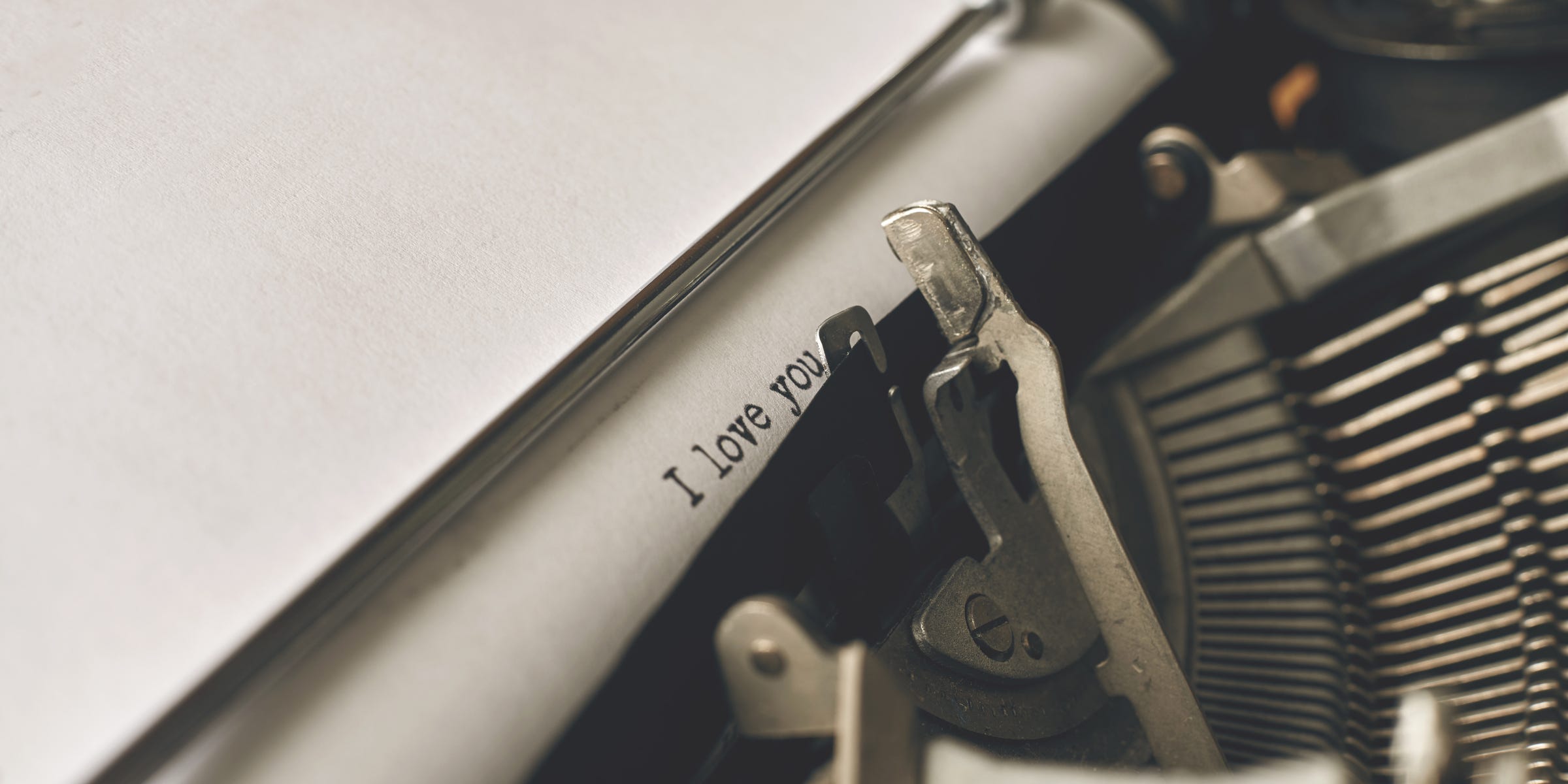 Typewriter with "I love you" typed on page - how to fall in love with writing