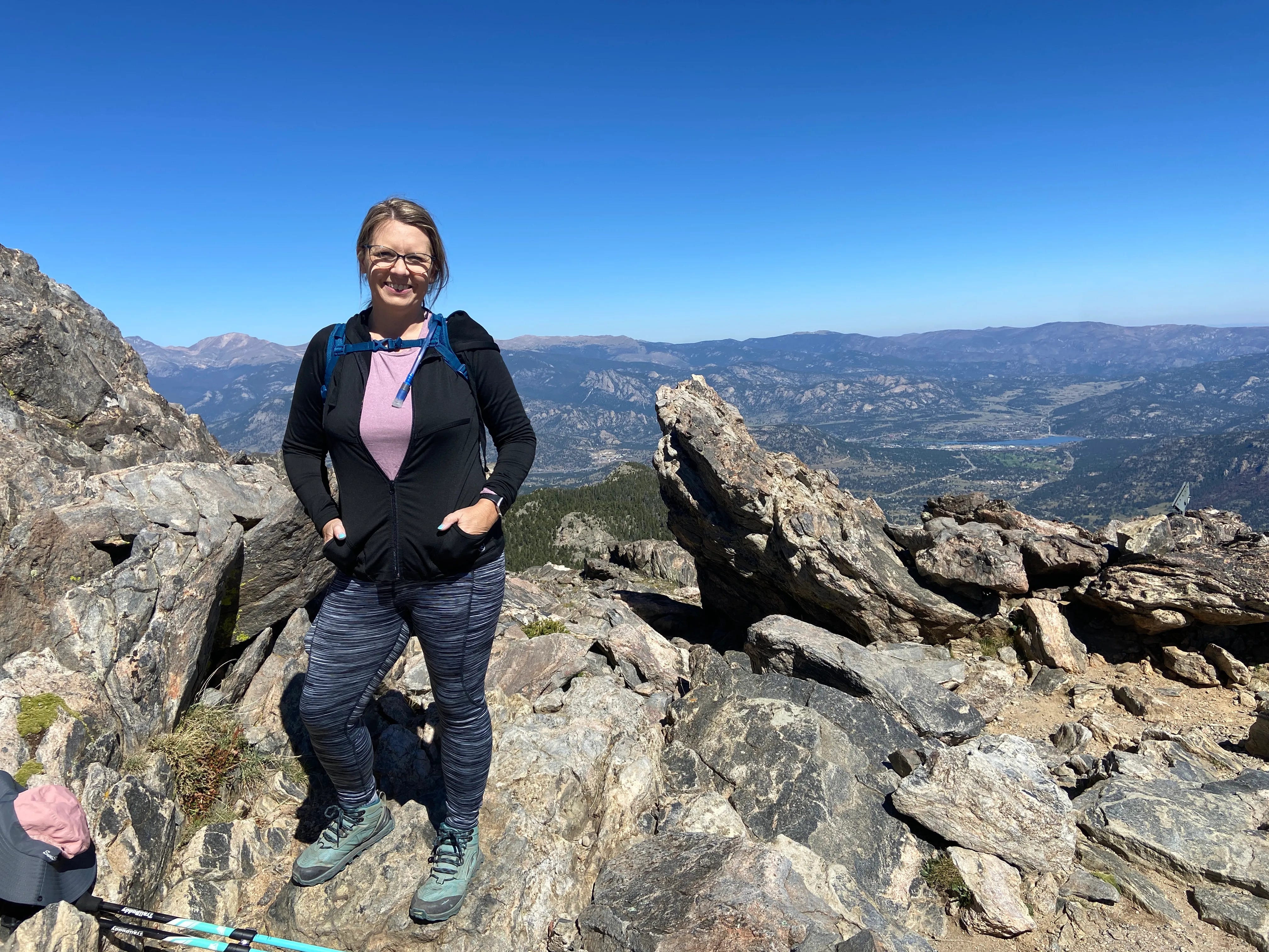 Donetta Dalman standing on top of Twin Sisters Peak