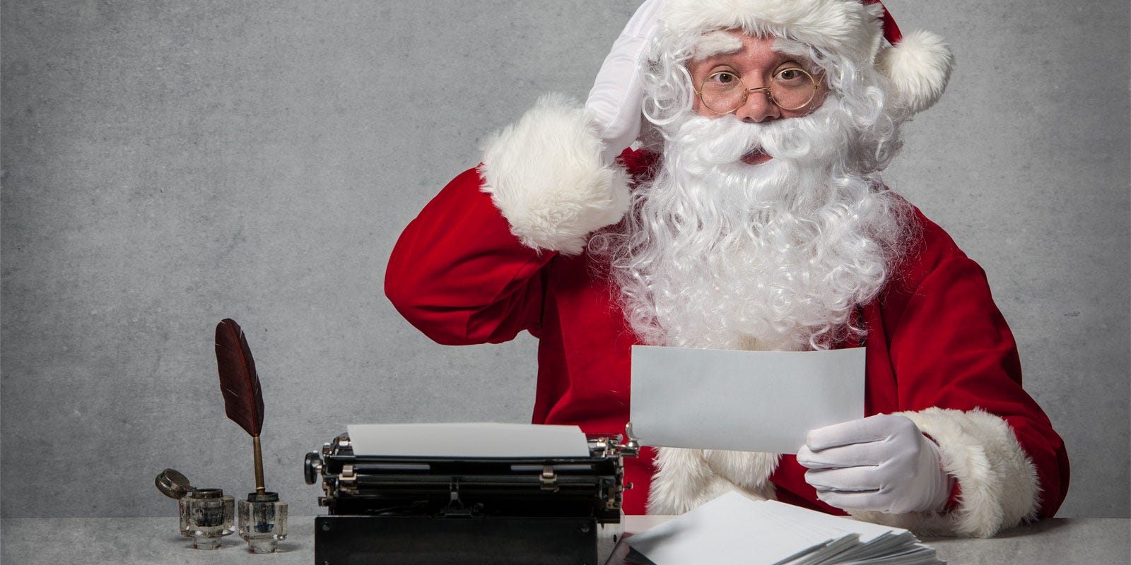 Santa trying to figure out what to write.