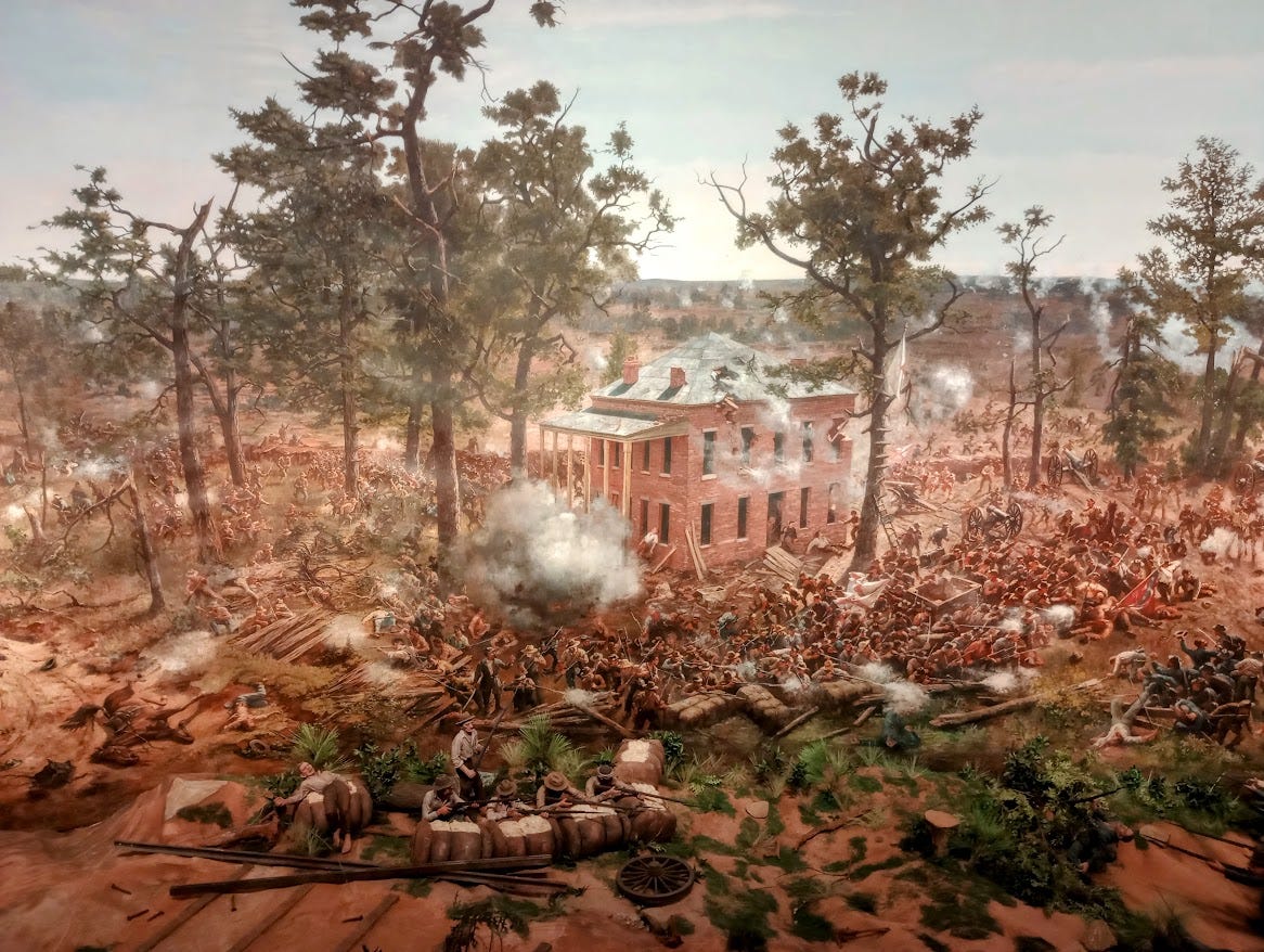 Battle scene from Civil War with large house at center surrounded by smoke, damaged trees, and masses of troops fighting