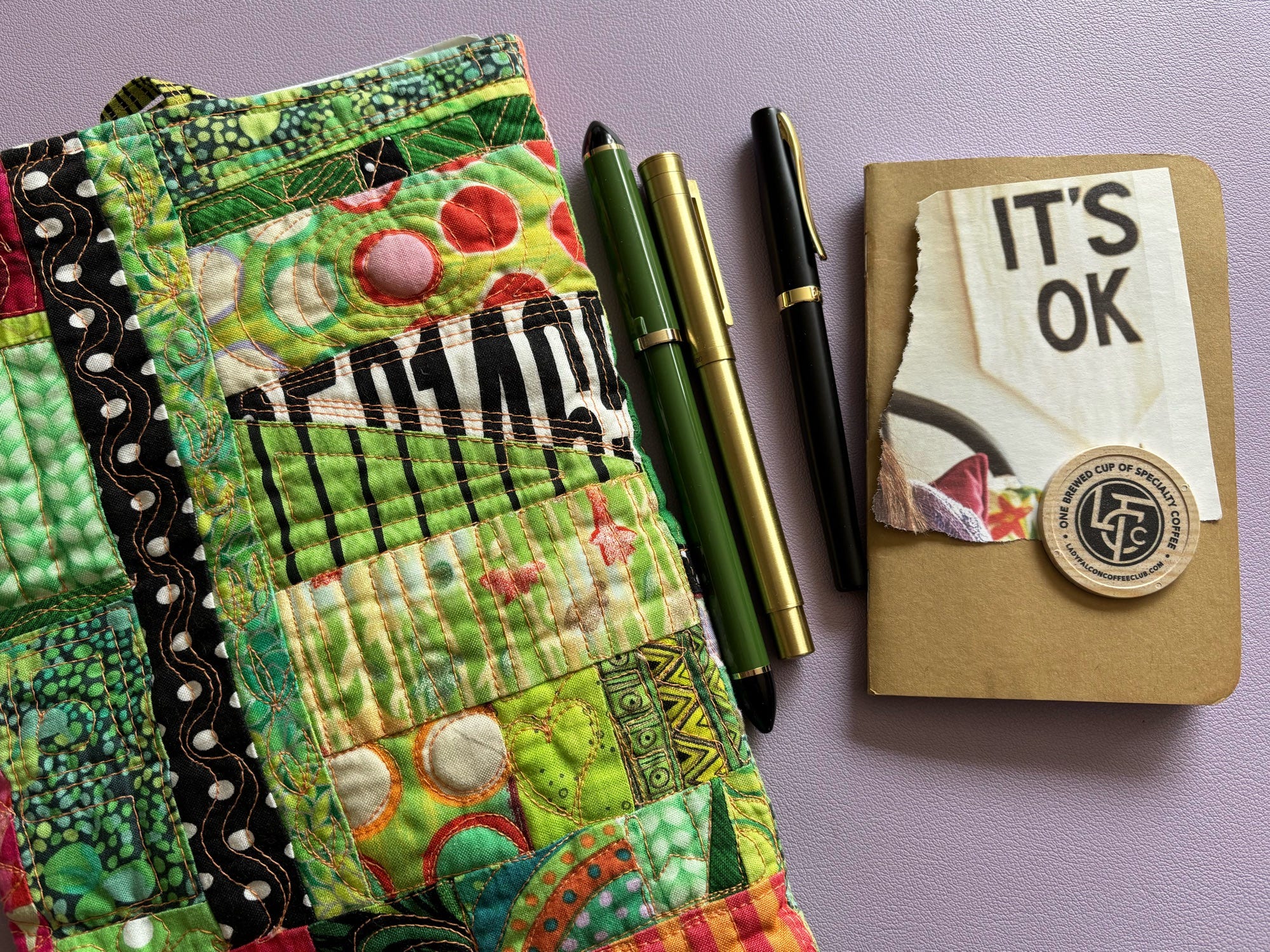 Fude pens next to a quilted bag