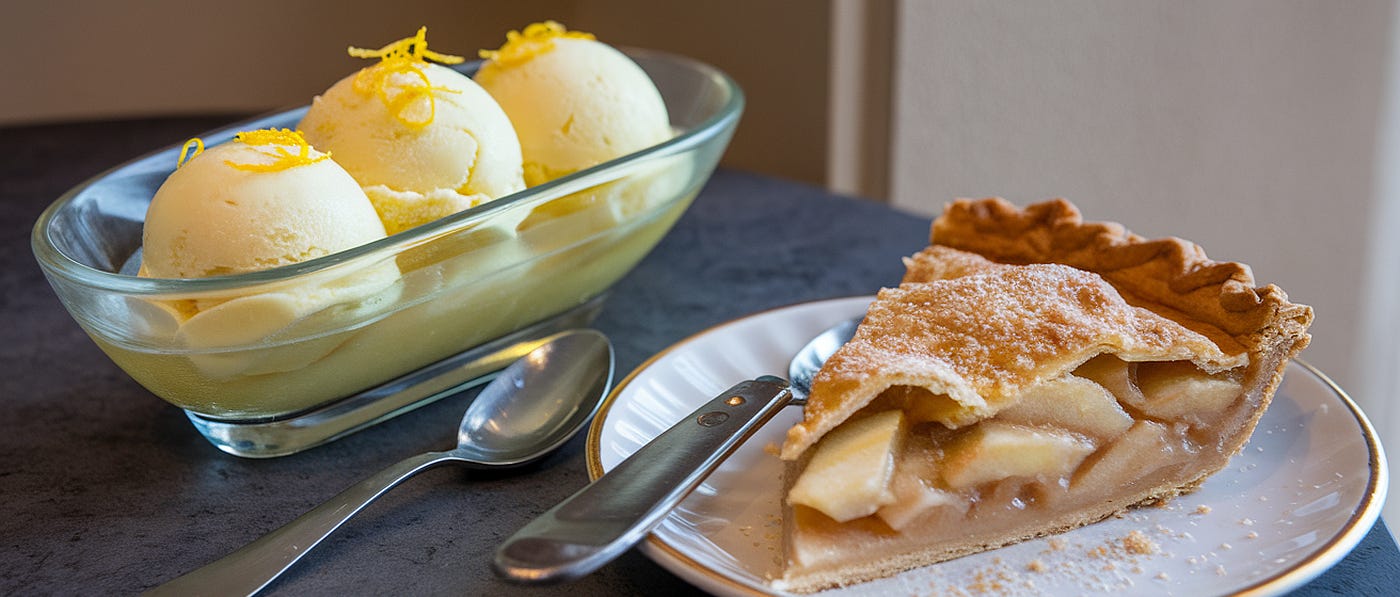 Two desserts: a lemon sorbet, and a slice of apple pie