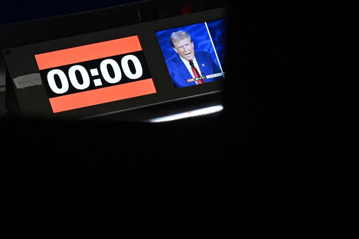 Trump appears on a screen next to the debate's countdown clock. Saul Loeb/AFP/Getty Images.