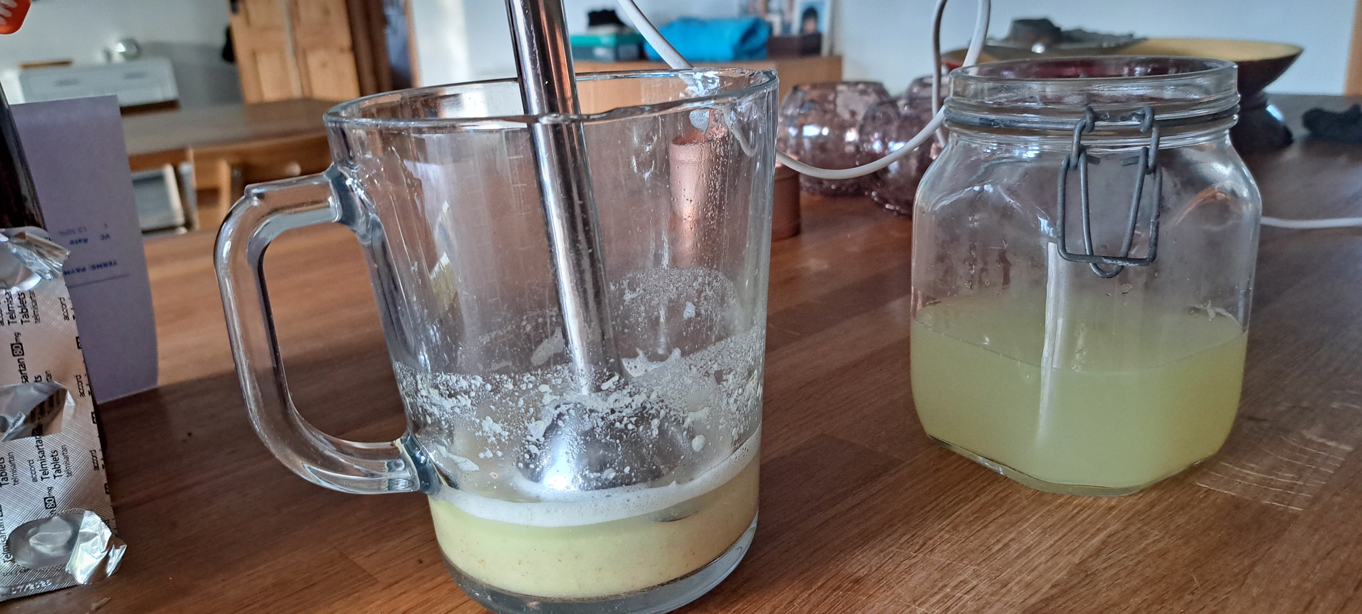 A glass jar on the right contains the yellowish liquid after the conkers have been removed. In the jug, I added more boiling water to the softened conkers and blended them, the blender sist in the pureed conkers.