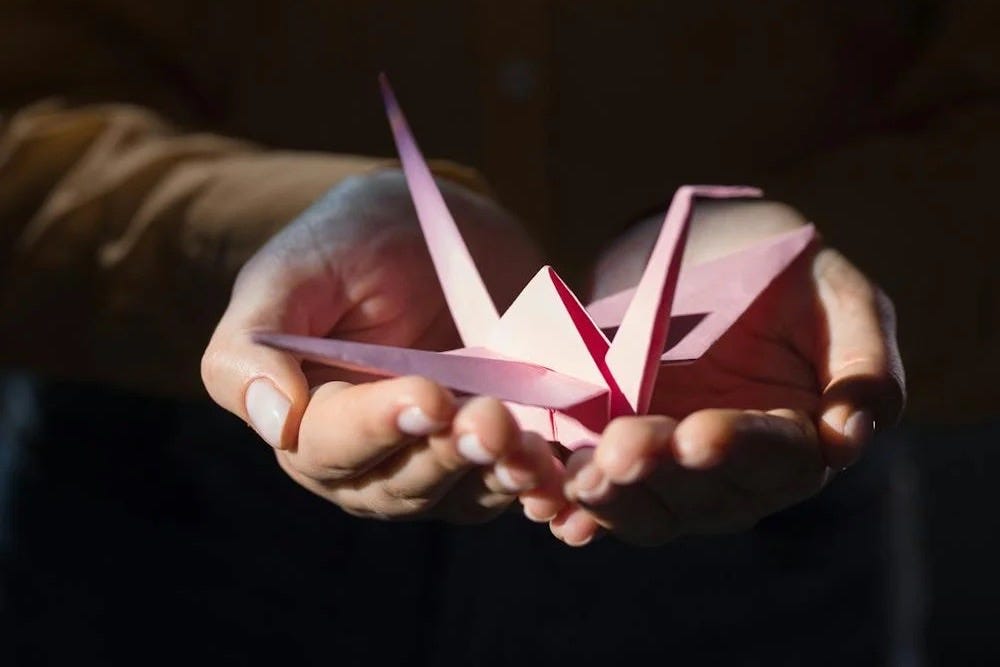 Woman holding paper crane