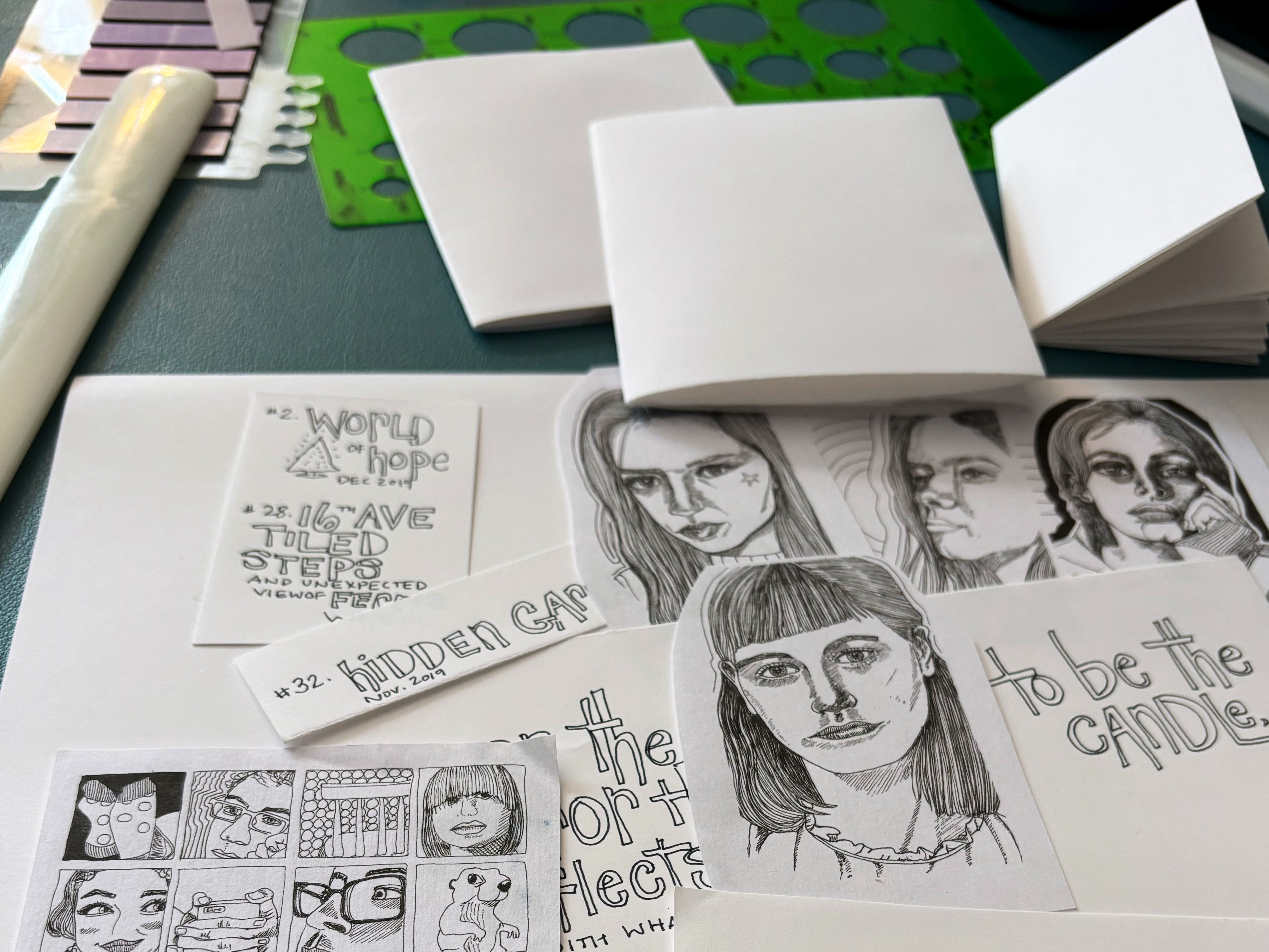 Portraits and other elements being laid out for a zine