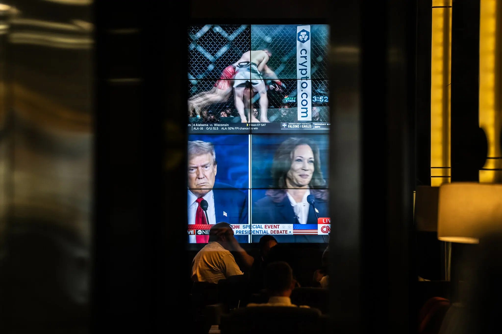 Patrons at a bar in downtown Philadelphia watching the presidential debate between Vice President Kamala Harris and former President Donald J. Trump on Tuesday night. Graham Dickie/The New York Times.