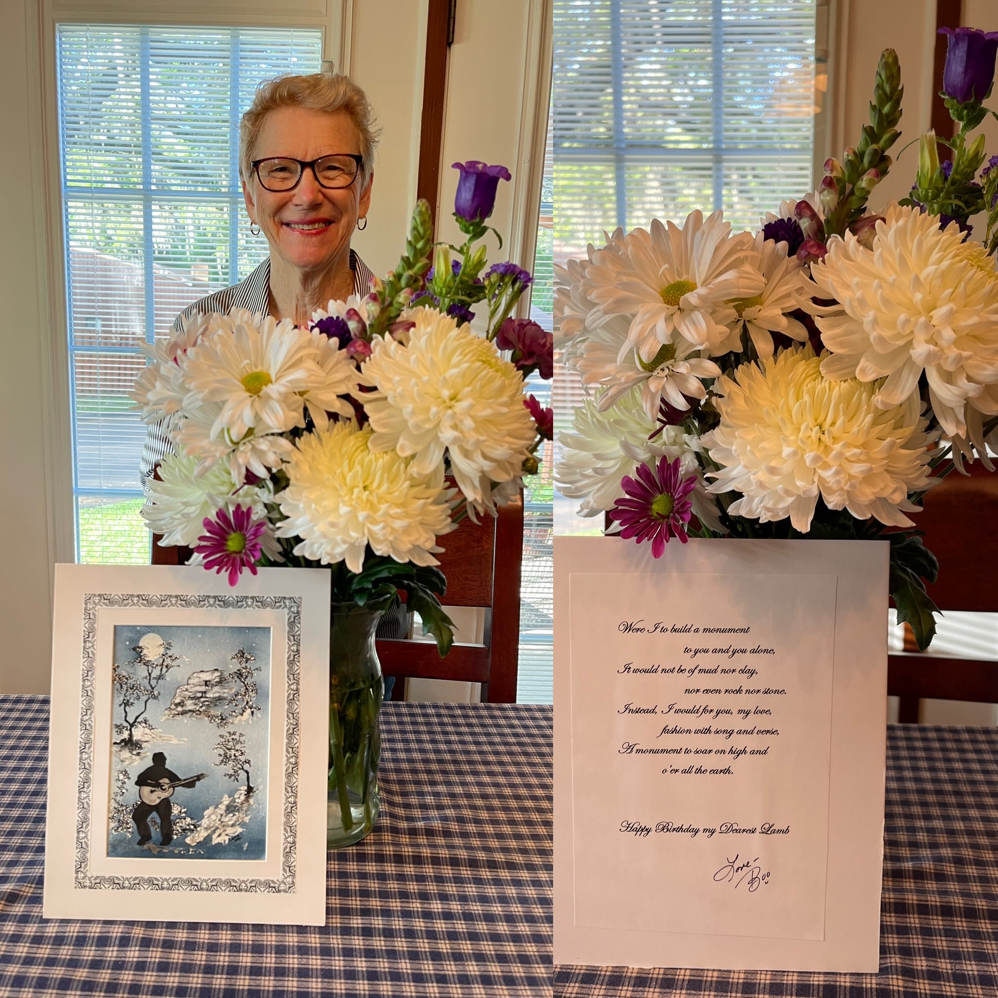 M.A. Hastings, who has short curly strawberry blonde hair, blue eyes and dark framed glasses, is standing behind a large bouquet of white and purple flowers in a glass vase. The flower vase   is on a navy and cream colored table cloth. In front of the flowers is a beautiful card M.A.’s husband,Lance Hastings painted as one of her birthday gifts.  The painting is framed in white matting with a leaf and heart border design dark black ink.  In the left foreground of the watercolor is a silhouette of a man strumming an acoustic guitar. The rest of the painting is in a Chinese style, with wisps of sparsely branched trees and delicate leaves in whites and grey.  The full white moon peaks out between two branches of the tree in the bluish grey background sky. The second image in the photo is the poem Lance wrote out in a cursive script on the back of the painting.  It reads:  Were I to build a monument to you and you alone, it would not be of mud or clay nor even rock nor stone. Instead, I would for you, my love, fashion with song and verse, a monument to sore on high and o’er all the Earth. Happy birthday, my dearest!