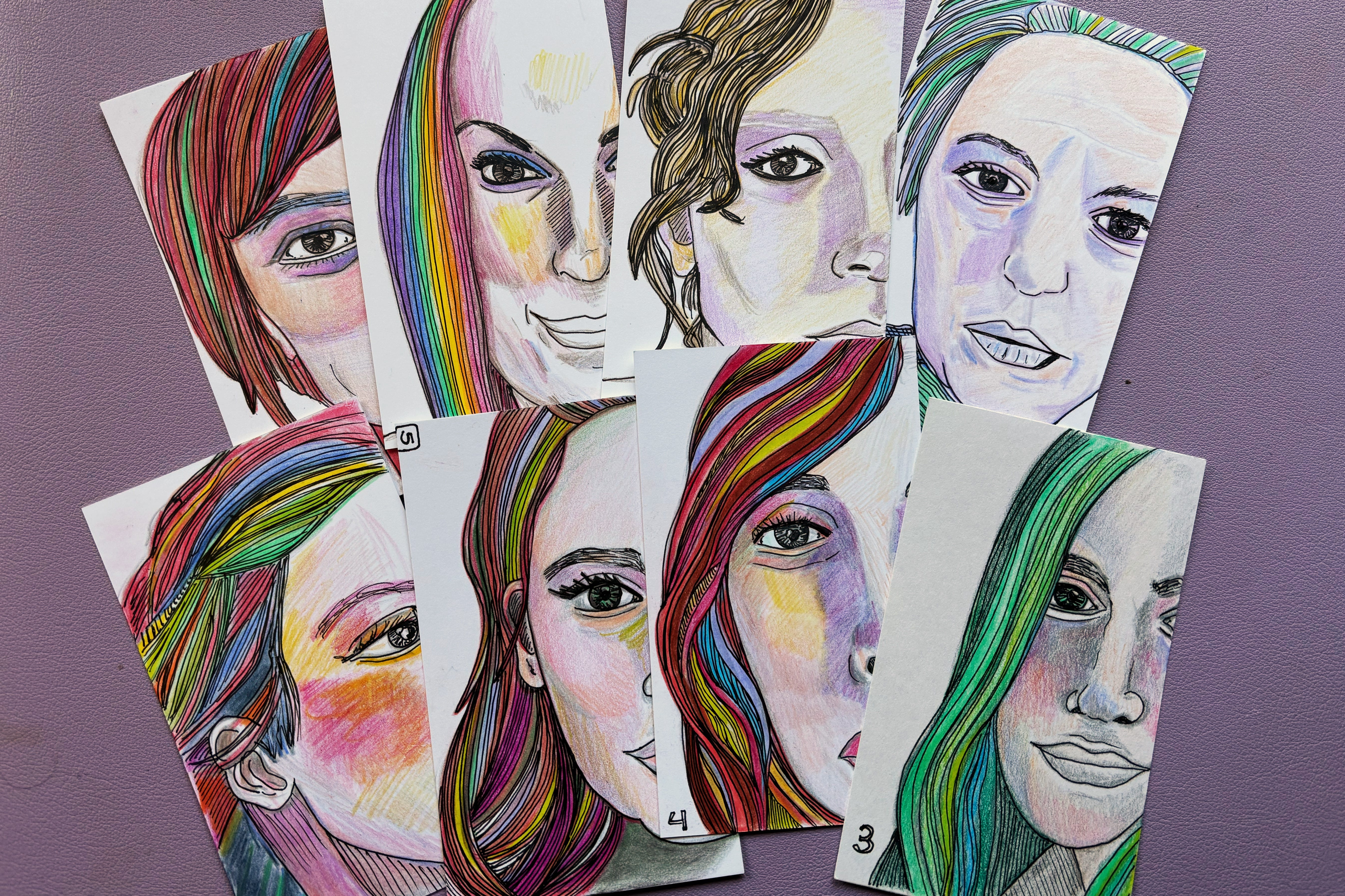 Portraits with rainbow hair on index card by Amy Cowen