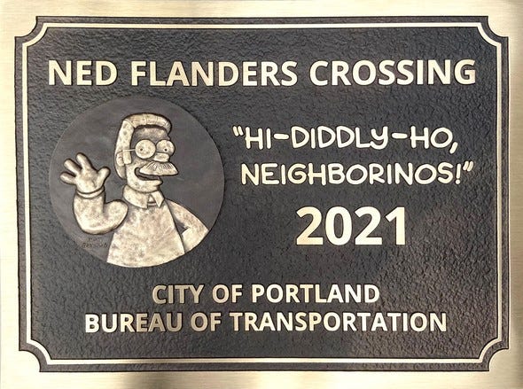 The Ned Flanders plaque is cast in bronze and features a bas relief of Ned Flanders waving next to his catchphrase “Hi-Diddly-Ho, neighborinos!”; at his elbow is Matt Groening’s signature.