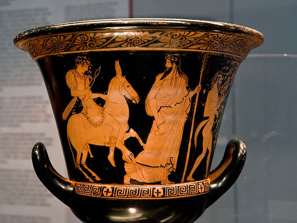 Attic red figure skyphos, on which Hephaestus returns to Olympus riding a donkey and carrying hammer and tongs. He is led by Dionysus, who bears a thyrsos (pine-cone tipped staff) and drinking cup.