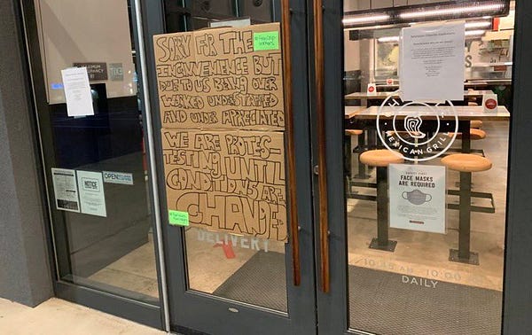 large sign posted on door of chipotle reads: “Sorry for the inconvenience but due to us being over worked understaffed and under appreciated we are protesting until conditions are changed”