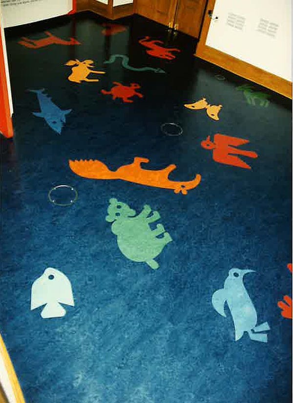 Photograph of a blue floor featuring stylized animals of all kinds, including a bear, fish, penguin, anteater, and moose.