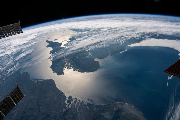 The sun's glint beams across the English Channel and the North Sea in between southern England and the coasts of France, Belgium and The Netherlands, in this photograph from the International Space Station as it orbited 263 miles above.